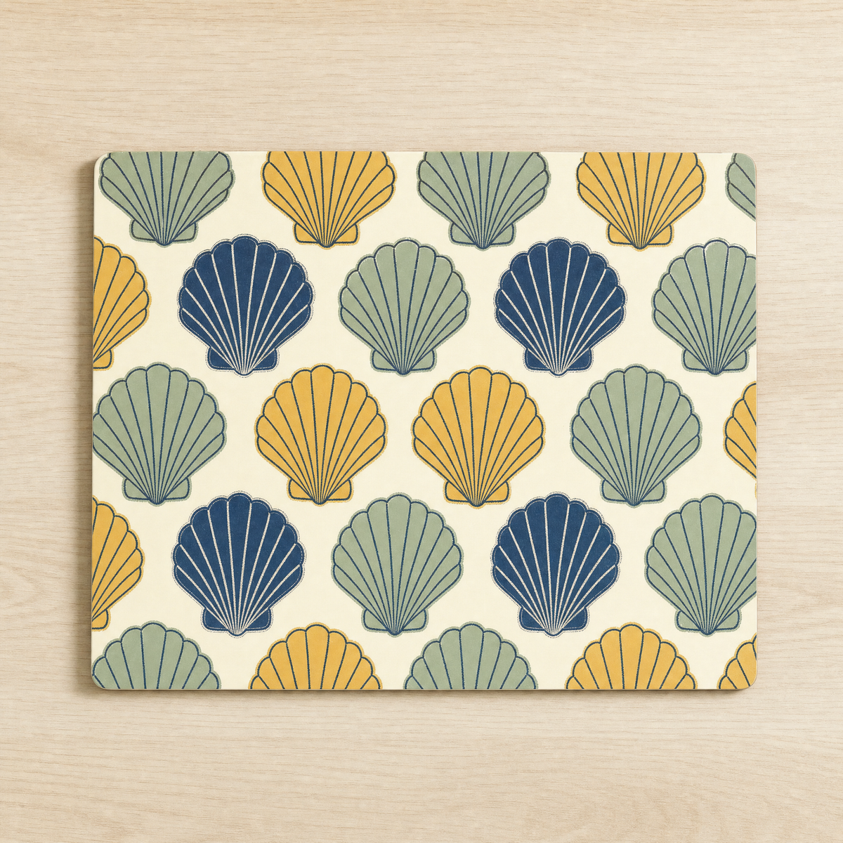 Glass worktop saver printed with repeating scallop shells in navy, sage and ochre